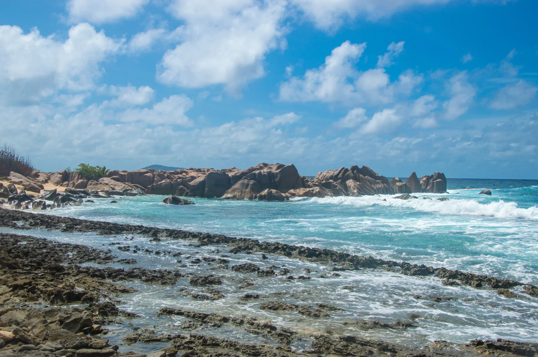 Waves breaking over coastal granite